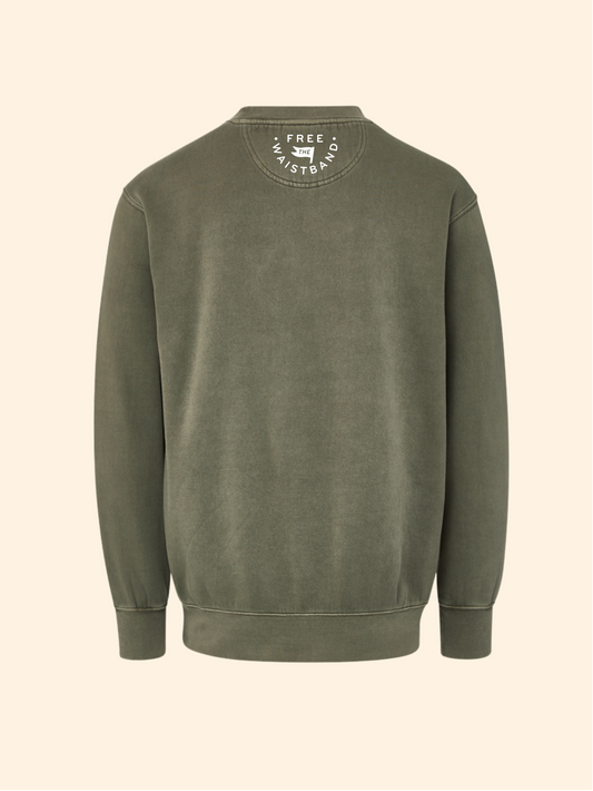 An olive green crewneck sweatshirt shown from the back, featuring a circular white graphic print on the inside of the collar, set against a solid cream background.