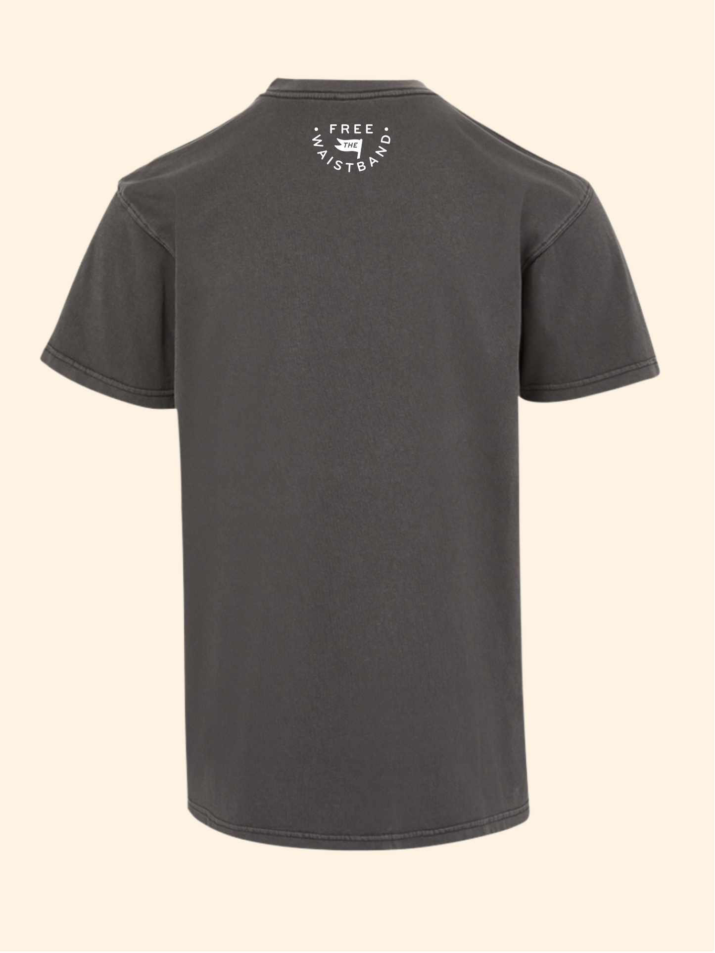 A dark gray short-sleeve t-shirt shown from the back, featuring a small white circular graphic on the upper back with the text 'FREE the waistband' and a small dog icon. The t-shirt is displayed against a solid, light cream-colored background.