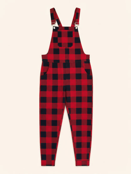Red and black buffalo plaid overalls with adjustable shoulder straps and side pockets, shown flat on a light cream background.