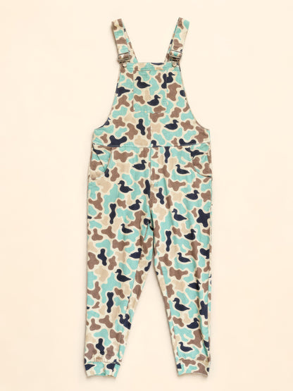 A pair of camouflage print overall jumpsuit in mint green, brown, beige, and black, shown flat against a light cream background.
