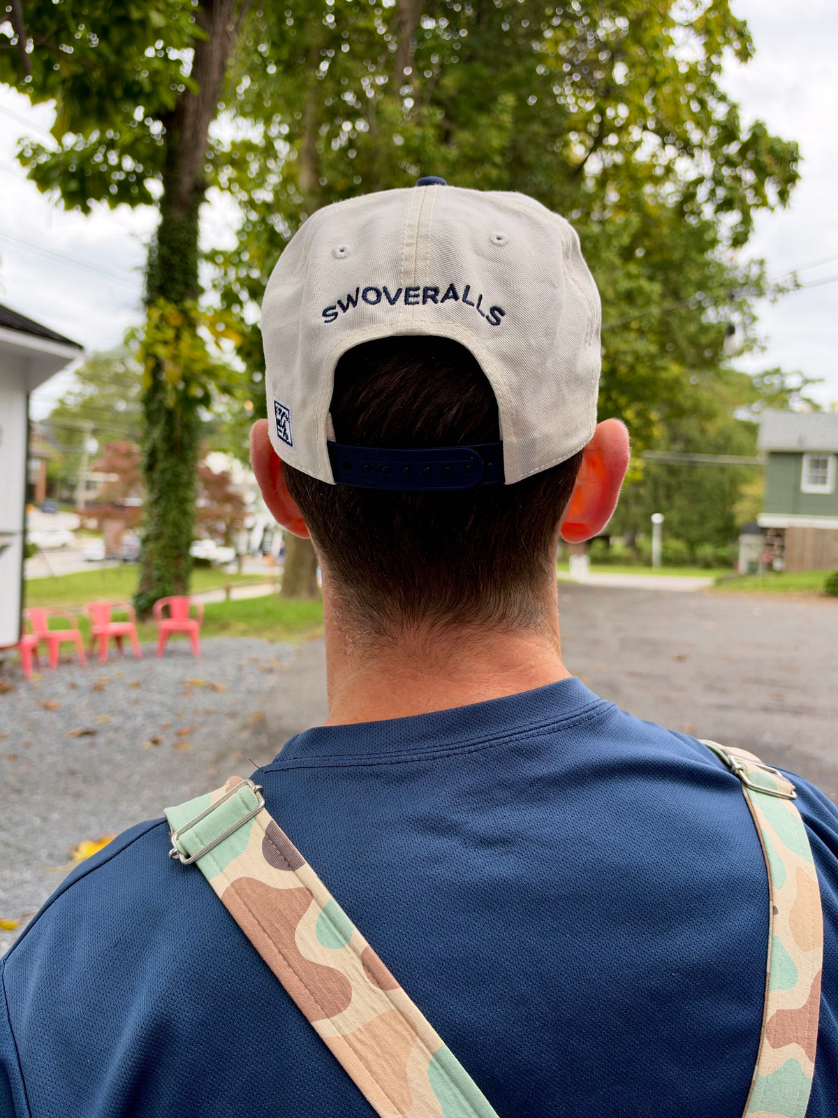 Back of the cream Good at Naps cap with navy Swoveralls embroidery and snapback strap
