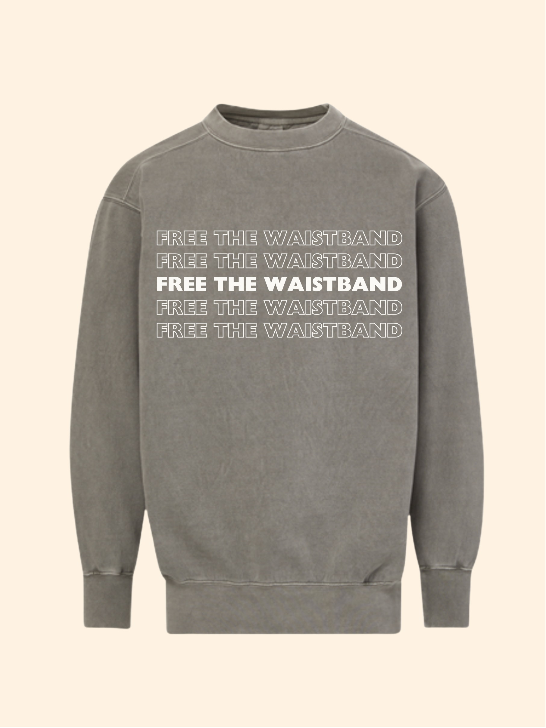 A gray crewneck sweatshirt with 'FREE THE WAISTBAND' printed in white across the chest, shown on a solid cream-colored background.