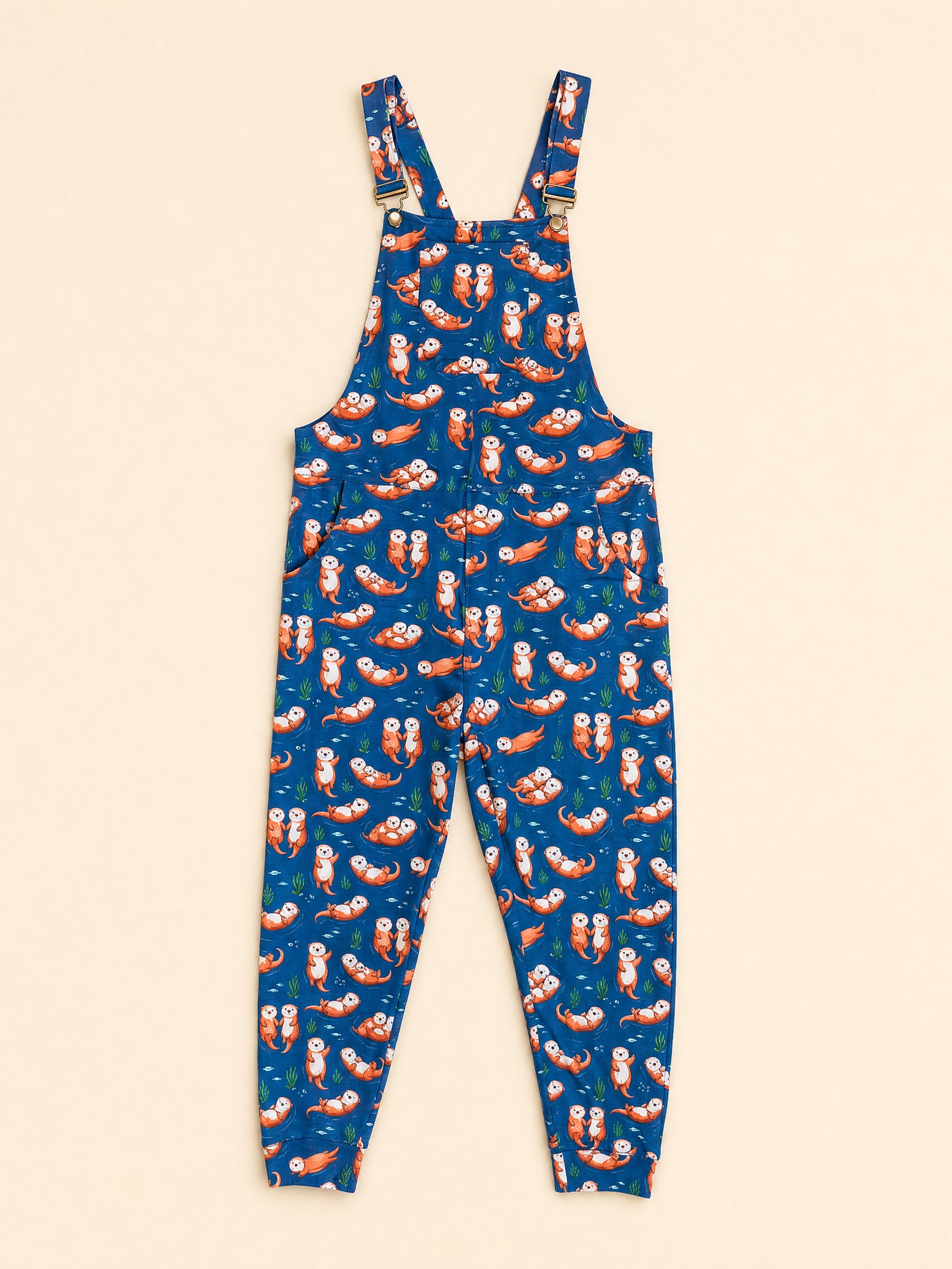 Blue overall jumpsuit with an all-over print of otters shown flat against a light beige background.