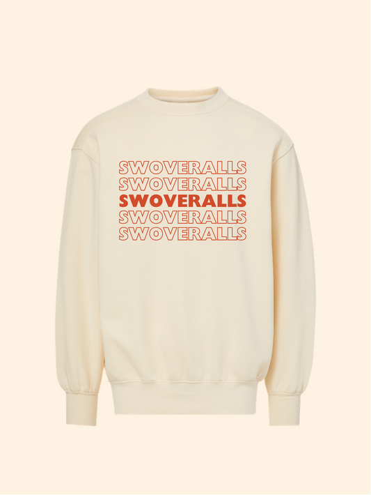 An off-white crewneck sweatshirt featuring a graphic print on the chest with the word 'SWOVERRALLS' repeated in orange outlines, with the middle line filled in solid orange. The sweatshirt is displayed against a solid cream-colored background.