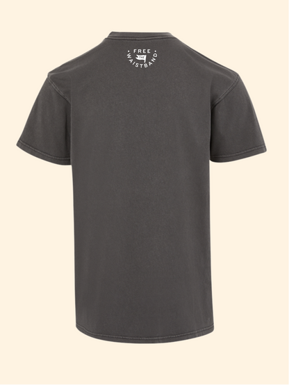 A dark gray short-sleeve t-shirt shown from the back, featuring a small white circular graphic on the upper back with the text 'FREE the waistband' and a small dog icon. The t-shirt is displayed against a solid, light cream-colored background.