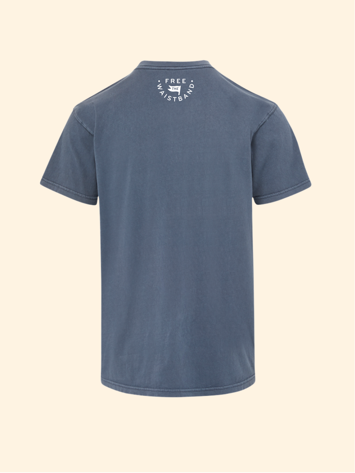 A slate blue short-sleeve t-shirt shown from the back, featuring a small white circular graphic on the upper back with the text 'FREE SKATEBOARD CO.' and a skateboard illustration, set against a solid cream background.