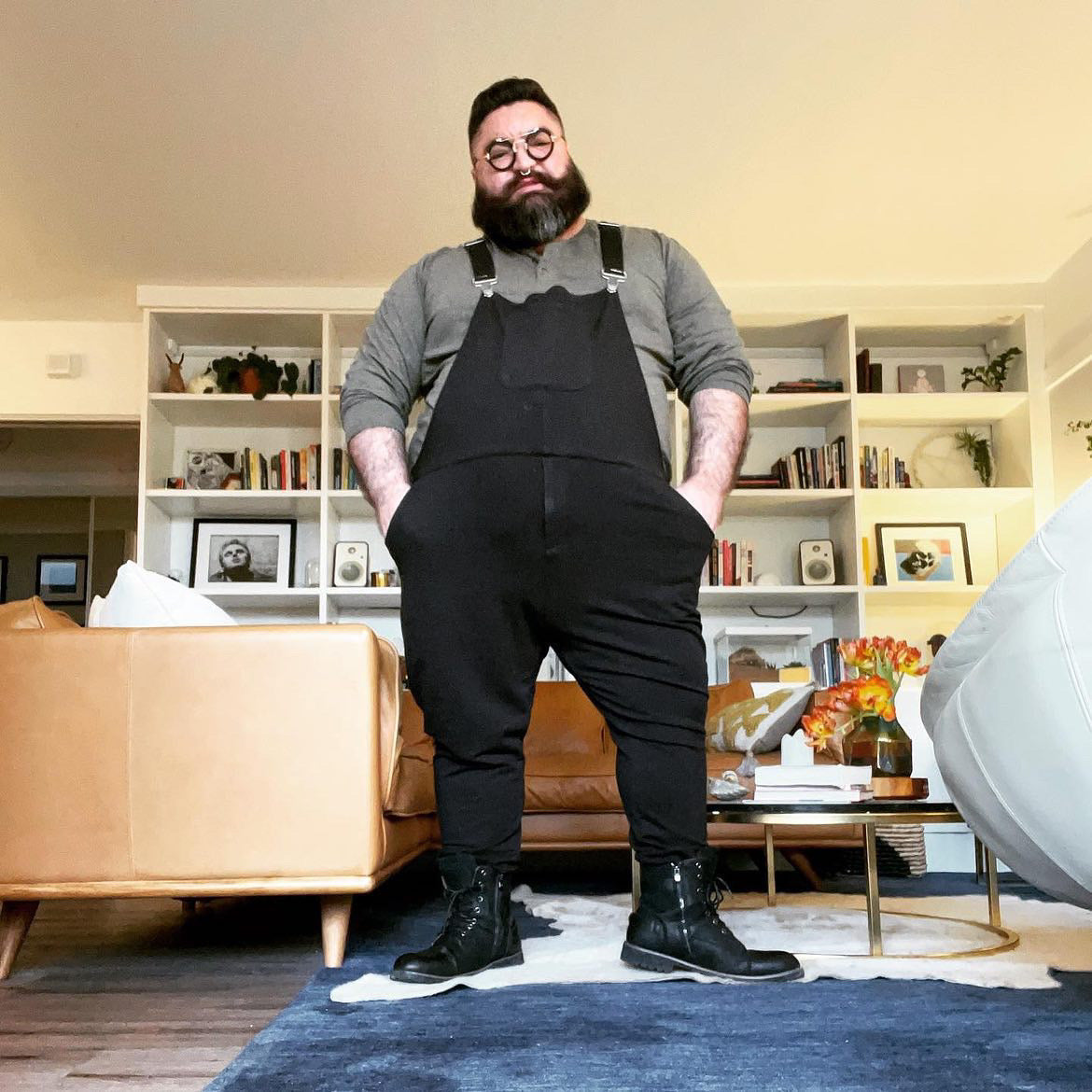 Ben Cuevas standing in a living room wearing Midnight Black Swoveralls with hands in the pockets